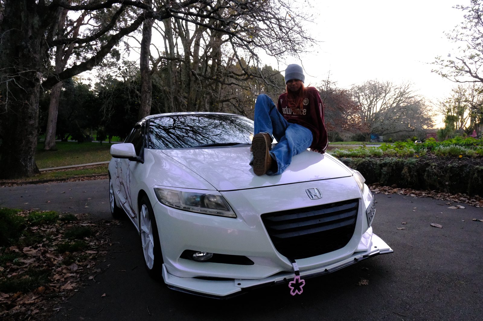 Clarissa's photography work — sitting on the hood of a Honda CR-Z at golden hour