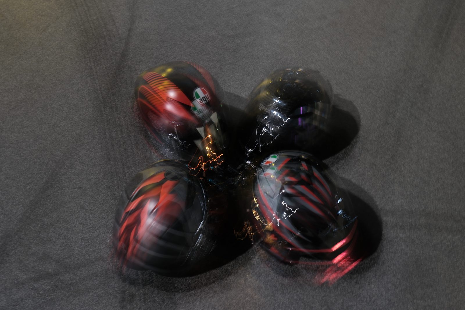 Clarissa's photography work — artistic motion-blur composition of four motorcycle helmets